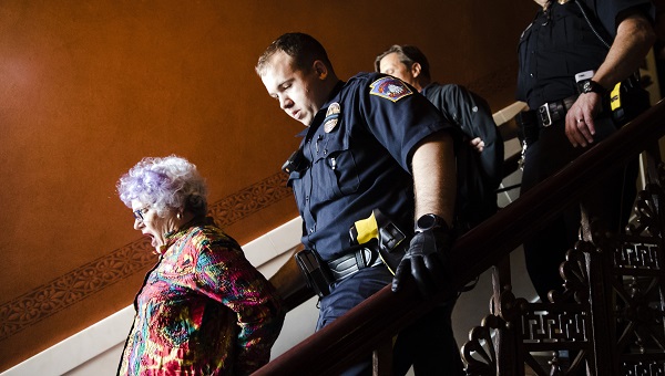 Carol Stowell, MoH York Chapter Leader, being arrested after interrupting House Session. Photo credit: AP
